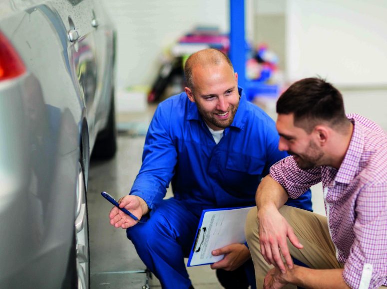 Mechaniker und Kunden besprechen Herstellergarantie beibehalten bei TOP Markenspezialist Scheffler und Spicker. Spezialist für Peugeot, Opel
